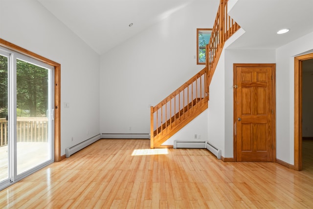 12 Cornwall Pl, Farmington, NH 03835 - unfurnished living room featuring stairs, light wood-style floors, a baseboard heating unit, high vaulted ceiling, and recessed lighting