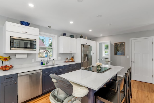 34 Leonard St, Rochester, NH 03867 - kitchen featuring stainless steel appliances, a breakfast bar area, plenty of natural light, recessed lighting, and a kitchen island