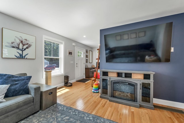 34 Leonard St, Rochester, NH 03867 - living area with wood finished floors, recessed lighting, and a glass covered fireplace