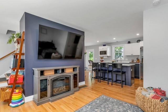 34 Leonard St, Rochester, NH 03867 - living room with light wood finished floors and recessed lighting