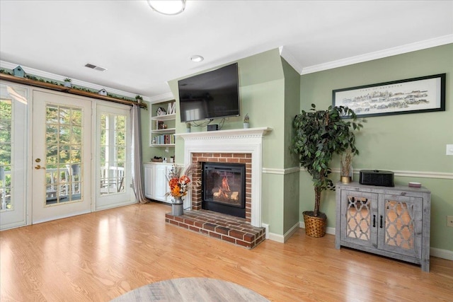187 Eastern Ave Unit 303, Manchester, NH 03104 - living area featuring ornamental molding, a fireplace, and wood finished floors