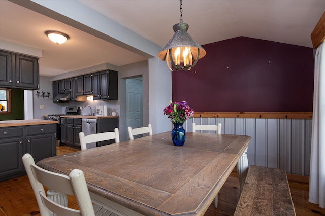 817 York Street Ext, Poultney, VT 05764 - dining area featuring wood finished floors, a chandelier, and vaulted ceiling