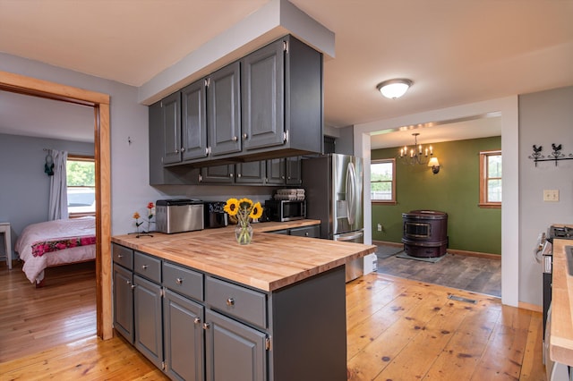 817 York Street Ext, Poultney, VT 05764 - kitchen featuring butcher block counters, stainless steel appliances, light wood-style floors, gray cabinetry, and a chandelier