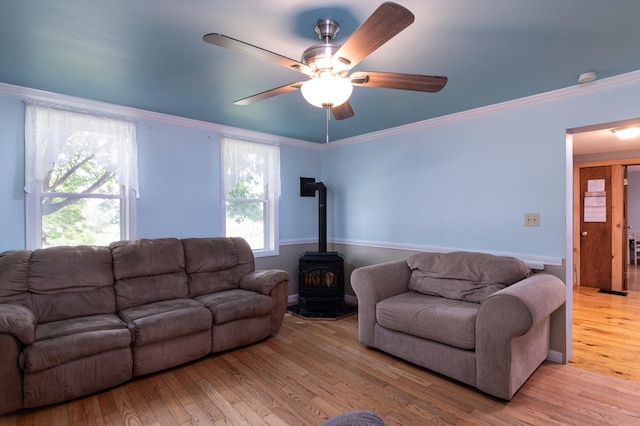 817 York Street Ext, Poultney, VT 05764 - living room with a wood stove, light wood finished floors, ceiling fan, and crown molding