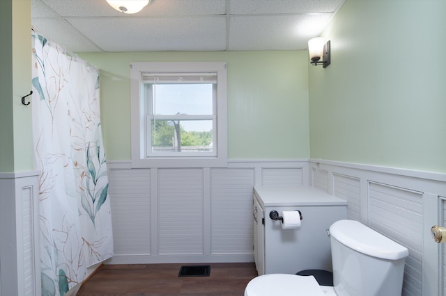 817 York Street Ext, Poultney, VT 05764 - bathroom featuring a wainscoted wall, a drop ceiling, curtained shower, and wood finished floors
