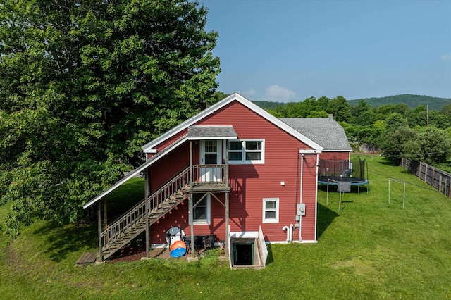 817 York Street Ext, Poultney, VT 05764 - rear view of house with a trampoline, stairway, and a shingled roof