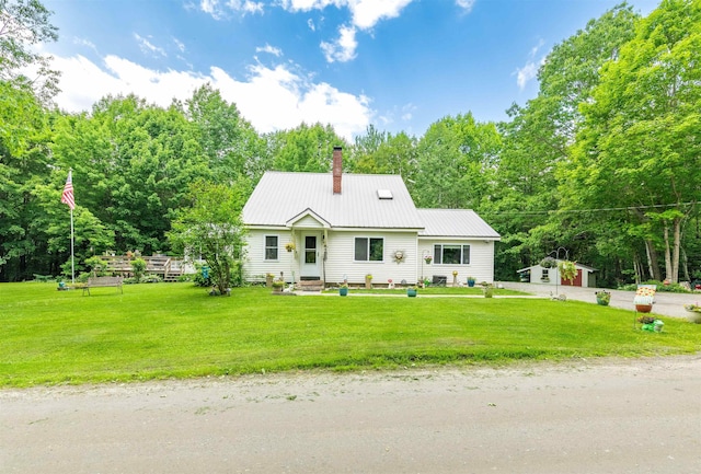 1307 Lime Kiln Rd, Haverhill, NH 03780 - view of front facade with a chimney, a front lawn, a metal roof, and an outdoor structure