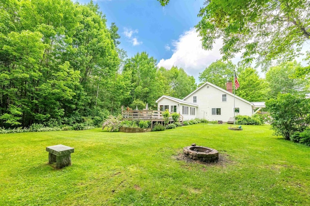 1307 Lime Kiln Rd, Haverhill, NH 03780 - view of grassy yard with an outdoor fire pit and a deck