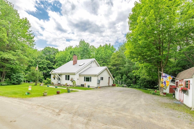 1307 Lime Kiln Rd, Haverhill, NH 03780 - view of front of property featuring dirt driveway, a chimney, a front yard, a metal roof, and a wooded view