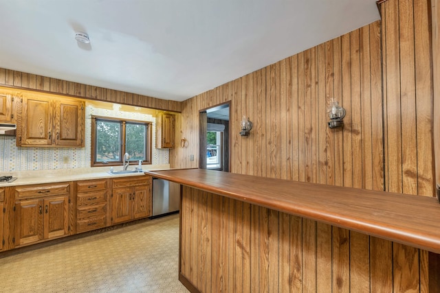 6 Davis Dr, Lebanon, NH 03766 - kitchen with stainless steel appliances, brown cabinetry, ventilation hood, and light countertops