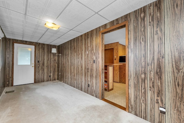 6 Davis Dr, Lebanon, NH 03766 - spare room with wood walls and carpet flooring