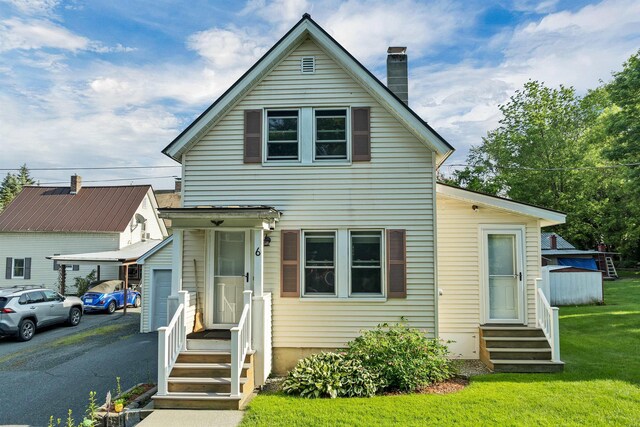 6 Davis Dr, Lebanon, NH 03766 - traditional home with entry steps, a chimney, driveway, and a front yard