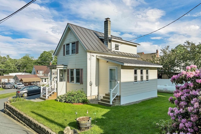 6 Davis Dr, Lebanon, NH 03766 - view of property exterior with a standing seam roof, entry steps, a metal roof, and a chimney