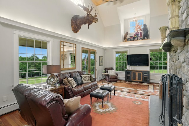 84 Shaw Rd, Northfield, NH 03276 - living room with a fireplace, high vaulted ceiling, wood finished floors, and healthy amount of natural light