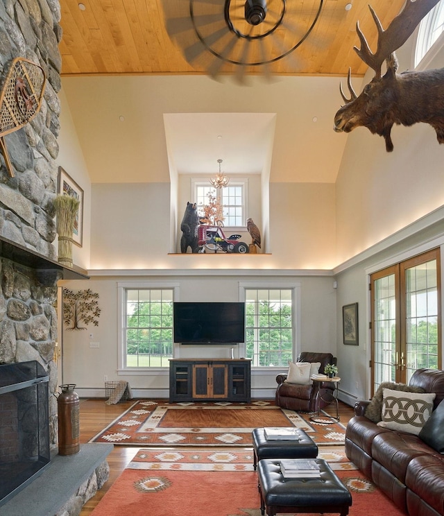 84 Shaw Rd, Northfield, NH 03276 - living room with a fireplace, high vaulted ceiling, healthy amount of natural light, wood finished floors, and wooden ceiling