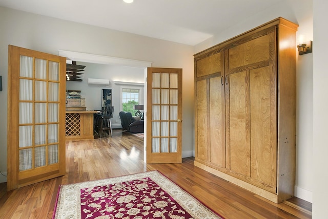 84 Shaw Rd, Northfield, NH 03276 - foyer featuring wood finished floors, a wall mounted air conditioner, and french doors