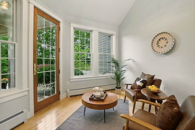 84 Shaw Rd, Northfield, NH 03276 - living area featuring baseboard heating, lofted ceiling, and light wood-style flooring