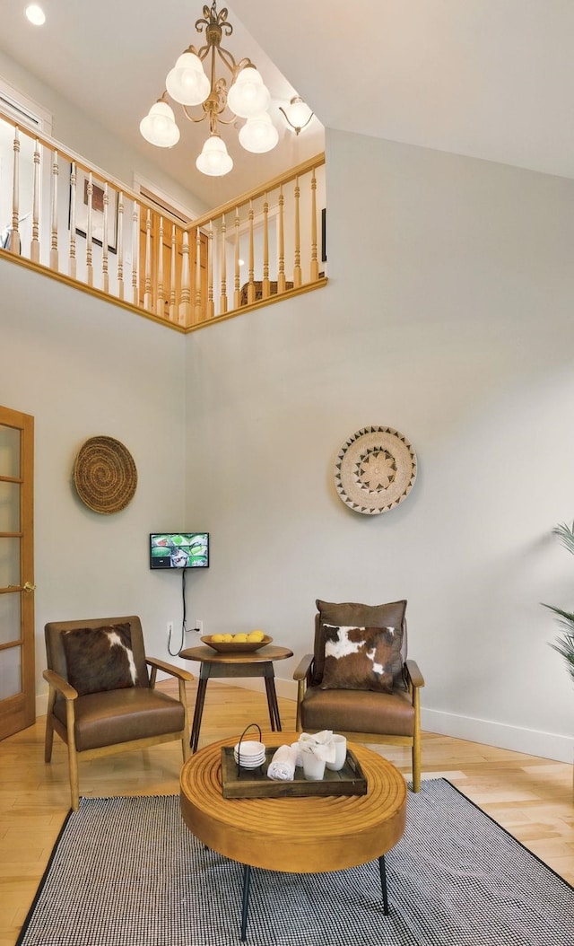 84 Shaw Rd, Northfield, NH 03276 - sitting room with wood finished floors, a chandelier, and a towering ceiling