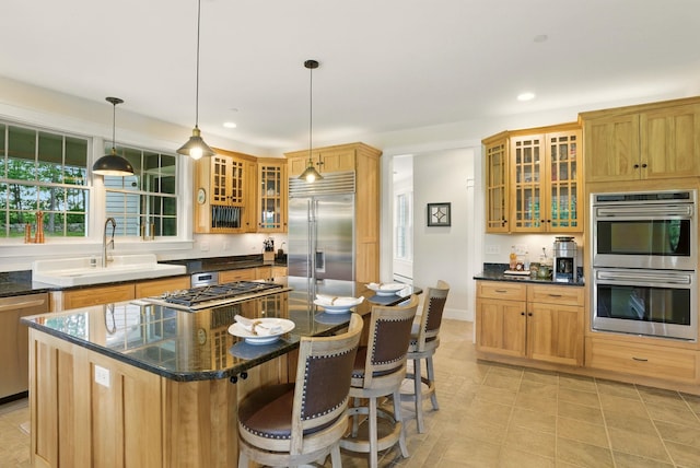 84 Shaw Rd, Northfield, NH 03276 - kitchen with stainless steel appliances, recessed lighting, glass insert cabinets, a kitchen bar, and hanging light fixtures