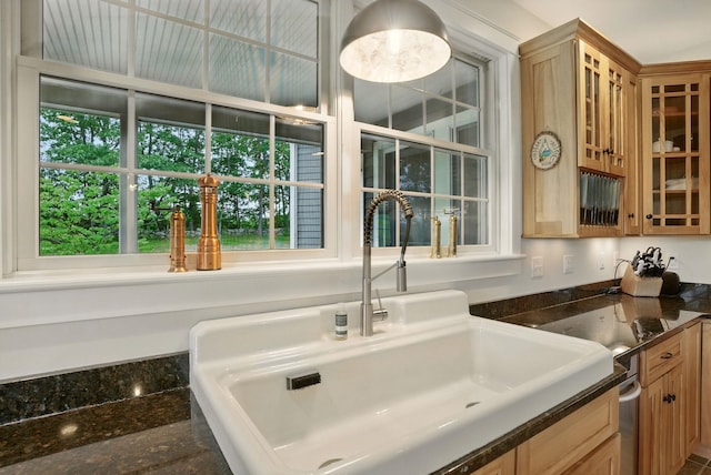 84 Shaw Rd, Northfield, NH 03276 - kitchen with dark countertops, healthy amount of natural light, glass insert cabinets, and light brown cabinetry