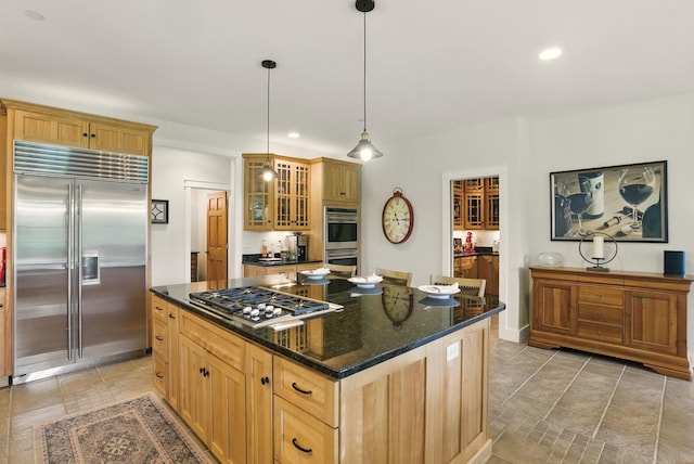 84 Shaw Rd, Northfield, NH 03276 - kitchen with stainless steel appliances, glass insert cabinets, a center island, dark stone countertops, and decorative light fixtures