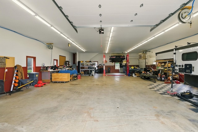 84 Shaw Rd, Northfield, NH 03276 - garage with a workshop area and a garage door opener