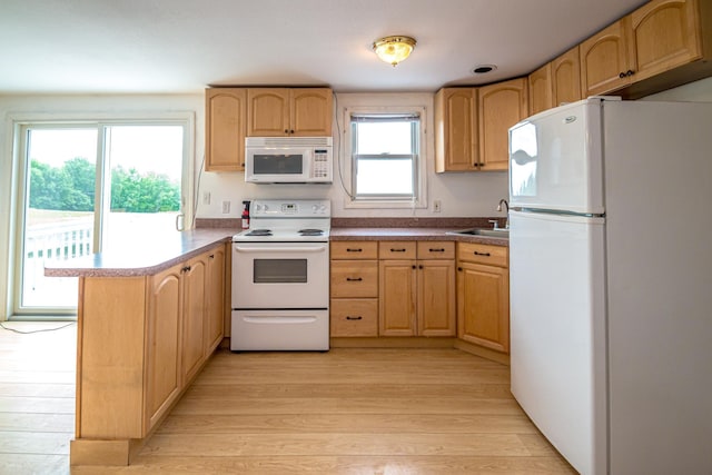 98 Rowell Rd, Lancaster, NH 03584 - kitchen featuring white appliances, a peninsula, light wood-type flooring, and light brown cabinets