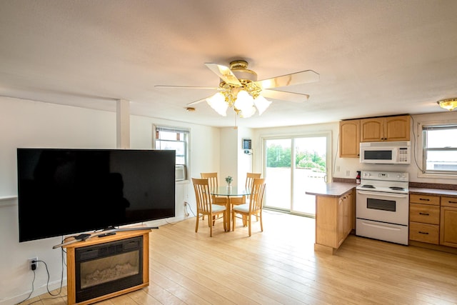 98 Rowell Rd, Lancaster, NH 03584 - kitchen with white appliances, ceiling fan, light wood-style flooring, and a peninsula
