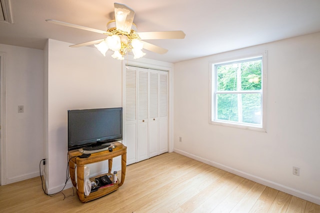 98 Rowell Rd, Lancaster, NH 03584 - bedroom with light wood-style flooring, a closet, and a ceiling fan