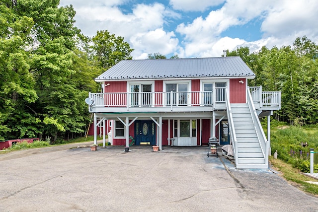 98 Rowell Rd, Lancaster, NH 03584 - view of front of home with stairway, a metal roof, a deck, and board and batten siding