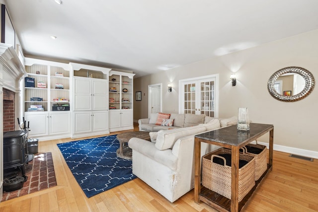 6 Walters Way, Exeter, NH 03833 - living area with a wood stove, light wood finished floors, and french doors
