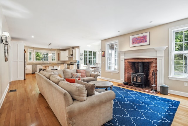 6 Walters Way, Exeter, NH 03833 - living area with light wood-type flooring, a wood stove, and recessed lighting