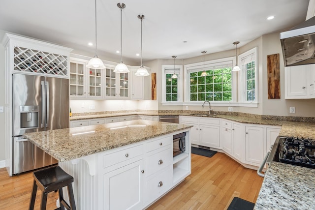 6 Walters Way, Exeter, NH 03833 - kitchen featuring stainless steel appliances, light wood-style flooring, ventilation hood, a kitchen island, and white cabinets