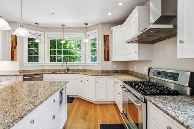6 Walters Way, Exeter, NH 03833 - kitchen with appliances with stainless steel finishes, wall chimney range hood, light wood-type flooring, white cabinetry, and recessed lighting