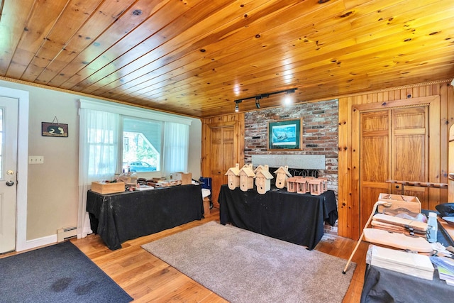 76 Cunningham Pond Rd, Peterborough, NH 03458 - living area with track lighting, baseboard heating, wood finished floors, and wooden ceiling