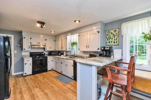 76 Cunningham Pond Rd, Peterborough, NH 03458 - kitchen featuring black appliances, under cabinet range hood, light wood finished floors, healthy amount of natural light, and recessed lighting