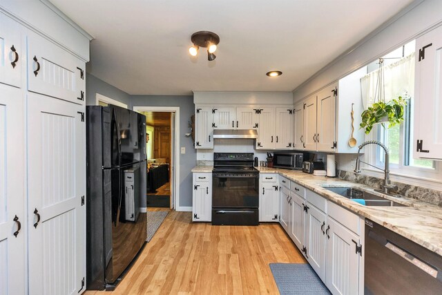 76 Cunningham Pond Rd, Peterborough, NH 03458 - kitchen with black appliances, under cabinet range hood, light wood-type flooring, and white cabinets