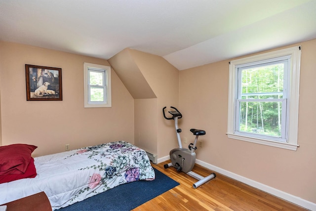 76 Cunningham Pond Rd, Peterborough, NH 03458 - bedroom featuring wood finished floors, vaulted ceiling, and a baseboard heating unit
