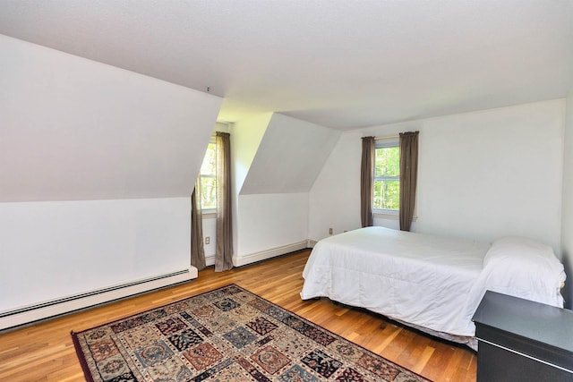 76 Cunningham Pond Rd, Peterborough, NH 03458 - bedroom with a baseboard heating unit, wood finished floors, and vaulted ceiling