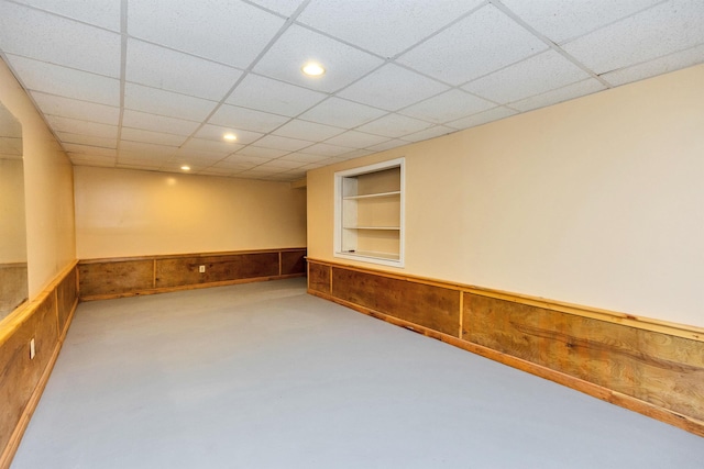 76 Cunningham Pond Rd, Peterborough, NH 03458 - empty room with built in features, a wainscoted wall, recessed lighting, a drop ceiling, and wooden walls