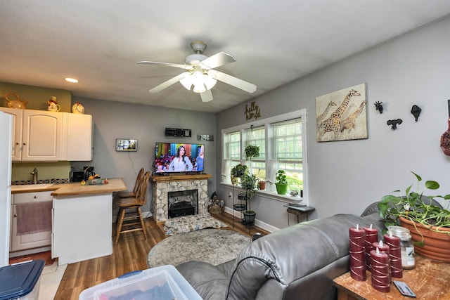 76 Cunningham Pond Rd, Peterborough, NH 03458 - living room featuring ceiling fan, light wood-style floors, recessed lighting, and a stone fireplace
