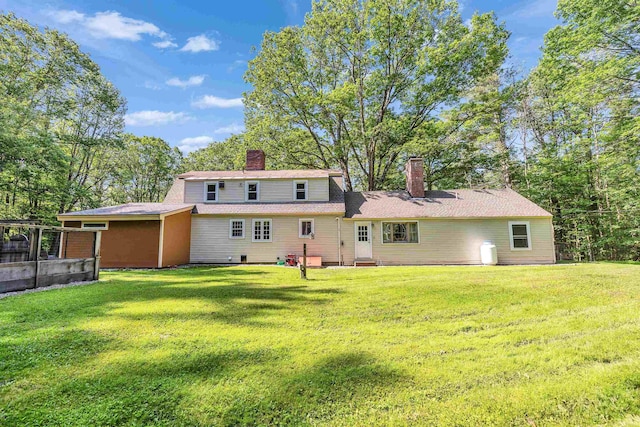 76 Cunningham Pond Rd, Peterborough, NH 03458 - rear view of property featuring a chimney, a lawn, and entry steps