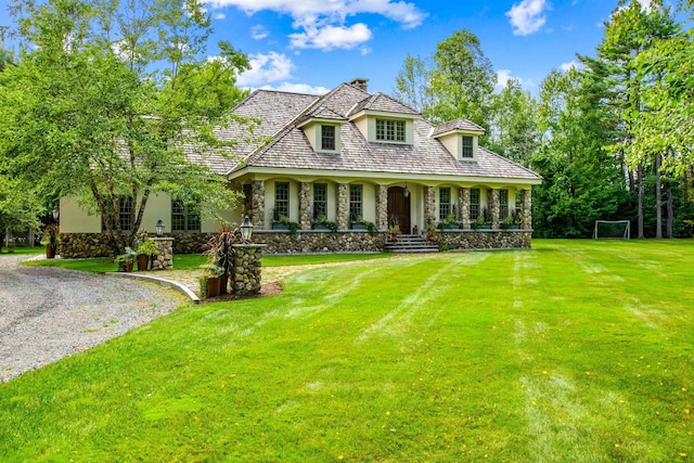 44 Buker Way, New London, NH 03257 - view of front of home with stone siding, a porch, a front yard, and stucco siding