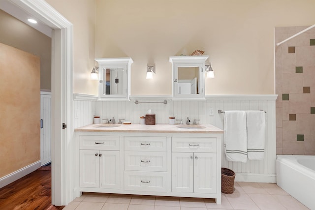 44 Buker Way, New London, NH 03257 - full bath featuring double vanity, a wainscoted wall, and shower / tub combination