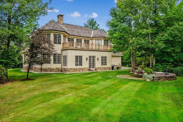 44 Buker Way, New London, NH 03257 - back of property featuring french doors, stucco siding, a balcony, a lawn, and a chimney