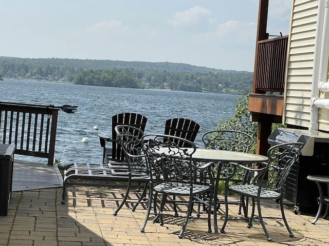 144 Lake St Unit 19, Laconia, NH 03246 - view of patio / terrace with a water view and a wooded view