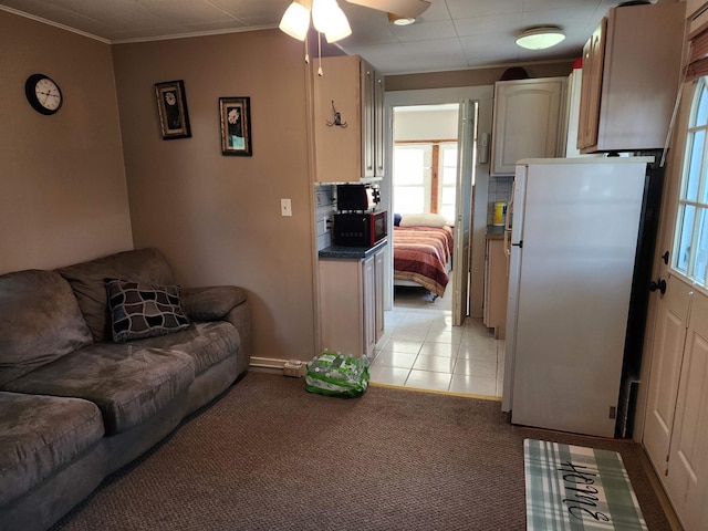 144 Lake St Unit 19, Laconia, NH 03246 - living area with light colored carpet, ornamental molding, a ceiling fan, and light tile patterned floors