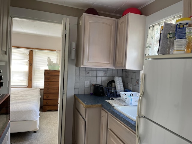 144 Lake St Unit 19, Laconia, NH 03246 - kitchen featuring freestanding refrigerator, tasteful backsplash, and dark countertops