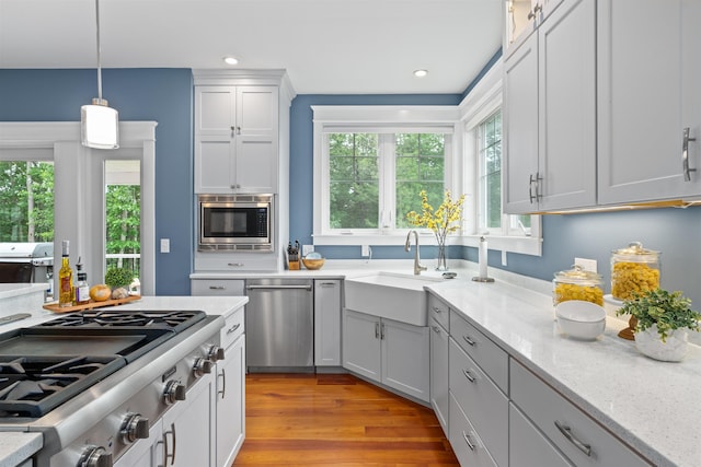 74 Childs Dr, Dover, NH 03820 - kitchen with stainless steel appliances, pendant lighting, light stone countertops, light wood-style flooring, and recessed lighting