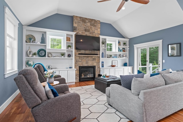 74 Childs Dr, Dover, NH 03820 - living area with lofted ceiling, ceiling fan, light wood finished floors, and a fireplace